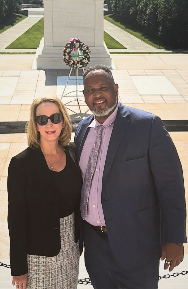 man and woman in front of memorial